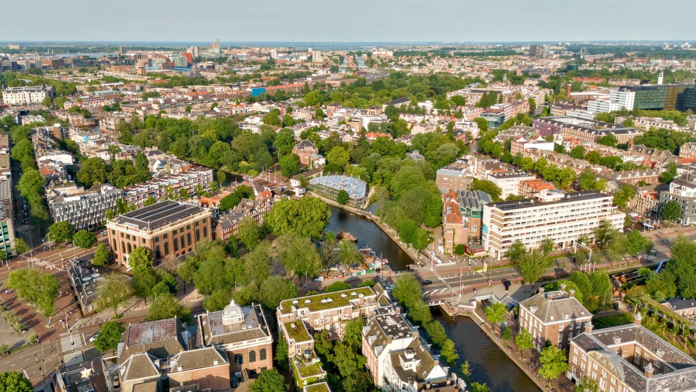 Aerial view of Amsterdam canals, parks and rooftops