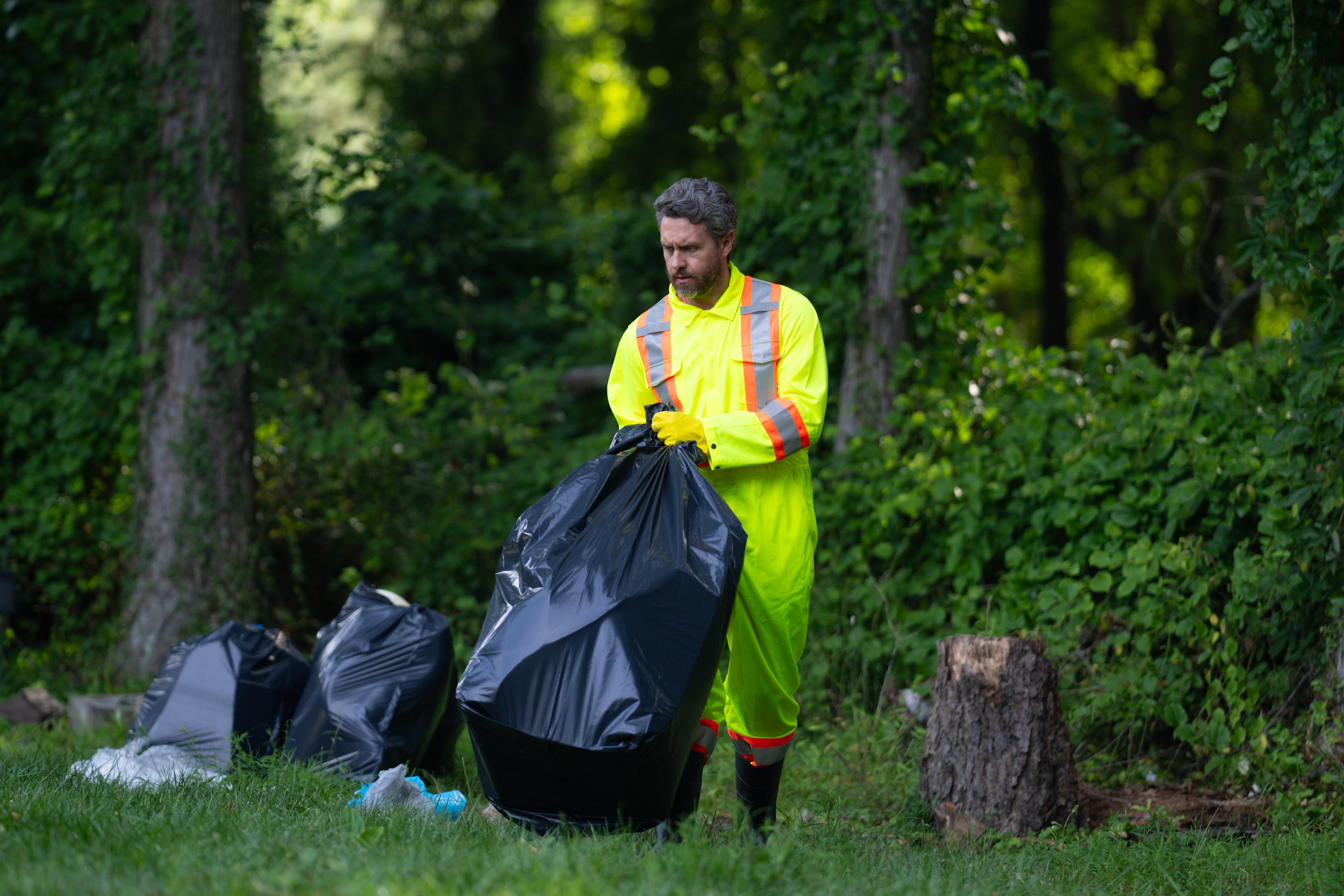A municipal worker clearing waste in a park